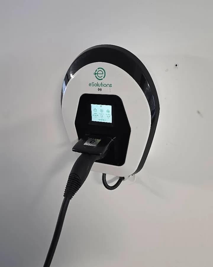 Carregador elétrico eSolutions instalado com o cabo de carregamento ligado